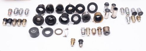 A collection of various microscope parts including lenses and objectives,