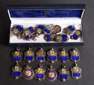 A collection of twenty- two Excelsior Football League silver and enamel prize medallions dating