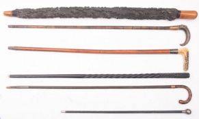 A group of five various walking sticks, comprising an antler handled stick, two horn handled sticks,