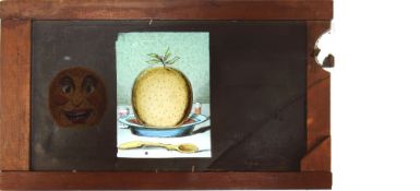 'Christmas pudding' [face appears] Maker unknown (6 7/8 x 4 x 3/8 inches), single slip.