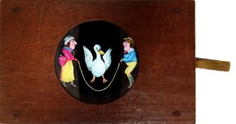 'Man and woman with skipping duck' Maker unknown (7 x 4 1/2 x 5/8 inches), single lever