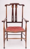 An Edwardian/Arts & Crafts elbow chair.