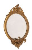 A gilt composition framed oval three-lig