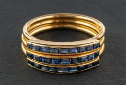 A step-cut, sapphire, three-row, half-eternity ring, length of ring head ca. 2cm, ring size U, total