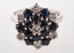 An 18ct gold, sapphire and diamond cluster ring, set with circular cut sapphires and brilliant cut