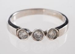An 18ct gold and diamond three stone ring, set with three brilliant cut diamonds, approximately 0.40