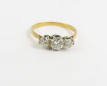 A diamond three stone ring, the three round brilli