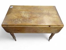 A Victorian pine Pembroke table on turned supports