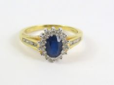 An 18ct gold sapphire and diamond cluster ring, wi
