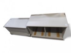 A light grey ottoman, with hinged lid and panel fr