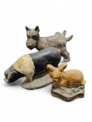 A painted metal doorstop in the form of a saddleba
