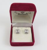 A pair of white gold diamond stud earrings, with a