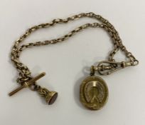 Gold-coloured oval locket pendant, horseshoe embossed with unmarked chain, bar and cornelian set