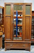 Early 20th century mahogany single door wardrobe, the door with bevelled edged mirror, flanked on