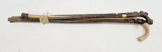 Rosewood-effect walking stick with gilt metal collar, two African carved figure walking sticks,