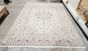 Central Persian Kashan cream ground carpet with central floral medallion on allover floral field and
