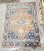 Modern Ghali rust ground carpet with central floral diamond enclosed by four floral lozenges on