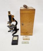 A vintage black lacquered “Kima” monocular microscope with wooden case by W. Watson & Sons of London