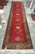 Large Russian Kazak red ground runner with seven elephant foot guls on stylized geometric pattern