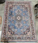 Modern blue ground rug with central herati motif on floral field and floral spandrels, multiple