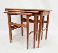 Nest of three mid-century teak side tables of rectangular form, raised on turned tapering legs,
