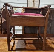 Mahogany upholstered piano stool with lift-up lid to seat