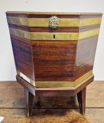 Georgian mahogany cellarette of octagonal form, brass-bound with two brass lion's head ring paw