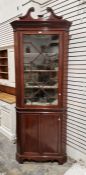 Edwardian mahogany corner cupboard with swan neck pediment  above astragal-glazed cupboard, on panel