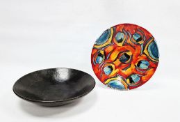 Poole Pottery Delphis charger with stylised floral decoration in blue, red and orange glaze,