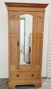 20th century pine single door wardrobe, the bevel edged glazed door opening to reveal hanging