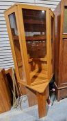 1970's teak corner cabinet, possibly by Ladderax or Staples, the single glazed door opening to
