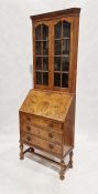 Early 20th century burr walnut veneer corner cabinet bureau, the top section having two glazed doors