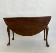 Antique mahogany drop-leaf dining table all on scroll carved cabriole supports, pointed pad feet,