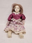 19th century wax over papier-mâché doll, with wax over papier-mâché arms, cloth body in a purple