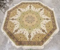 Modern octagonal green ground rug with central floral medallion on a floral field, single floral