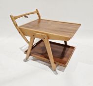 Late 20th century teak two-tier trolley on castors, the castors labelled 'Kenrick Mini Meteor, reg