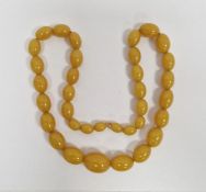 String of butterscotch yellow graduated amber beads, 70cm long approx.