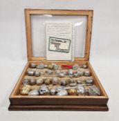 Collection of tea infusers, mainly stainless steel, from the 20th century, in a fitted box