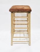 Stained wood and suede gym horse having turned rails to each side, on square supports, 102cm high