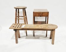 Stained wood cobbler's bench with shaped oval end and slats, a stained wood stool and a stained wood