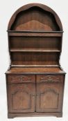 Stained oak dresser with arched top, three shelves, the base with two drawers and cupboards with