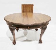 Mahogany wind-out dining table, oval with gadrooned border, having large acanthus carved tapering