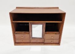 Stained wood cabinet, table-top, with shelves, central cupboard with mirrored door, small drawers