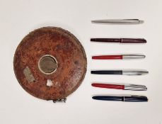 Various Parker fountain pens and biros and a vintage leather bound tape measure marked 100 feet