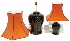 Large table lamp of baluster form with black glaze and gilt decoration and another smaller similar