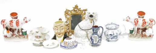 Staffordshire-style spaniel, a Sylvac Falconware Toby jug, a pair of Staffordshire flatback cows and