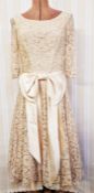 A vintage lace cocktail dress, labelled 'Fur Coat and No Knickers', pale beige lace with big satin