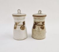 Pair of studio pottery stoneware lidded storage jars, brushwork floral motifs on speckled oatmeal
