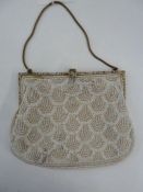 1920's white beaded evening bag, fixed frame with enamel decoration, red and blue flowers with green