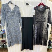 A 1970's maxi dress, empire line, navy blue skirt with lace bodice, puff sleeves and mandarin